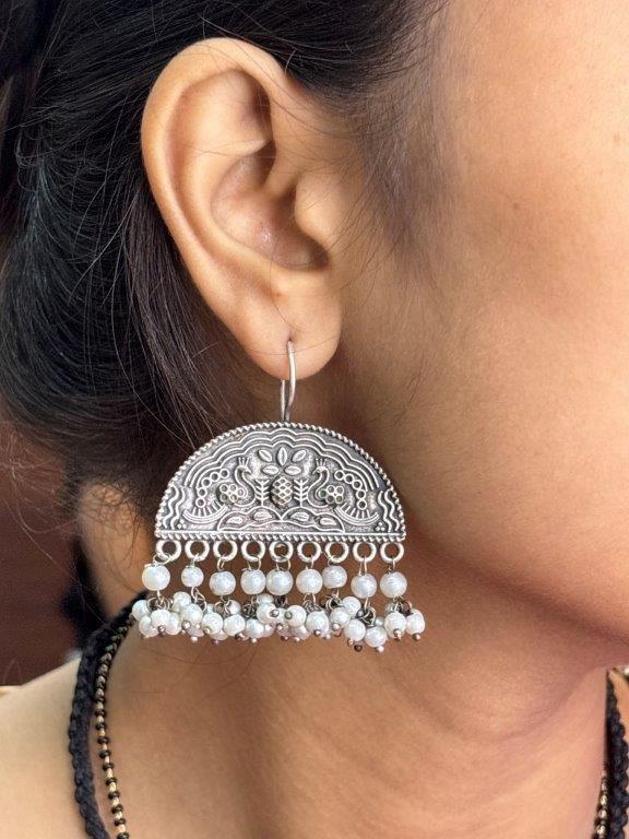 Model wearing oxidised silver-look jhumkas