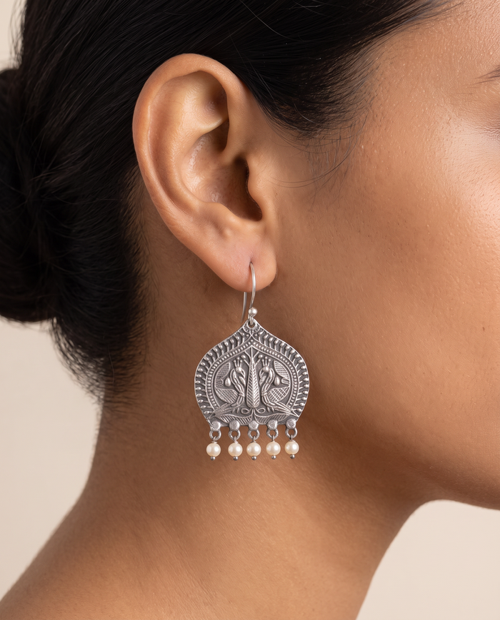 Madhuri paan leaf peacock earring with pearl drops worn on the earlobe