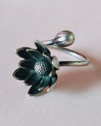 Oxidised silver-look brass adjustable ring with an open lotus bloom and a closed lotus bud on the wraparound band