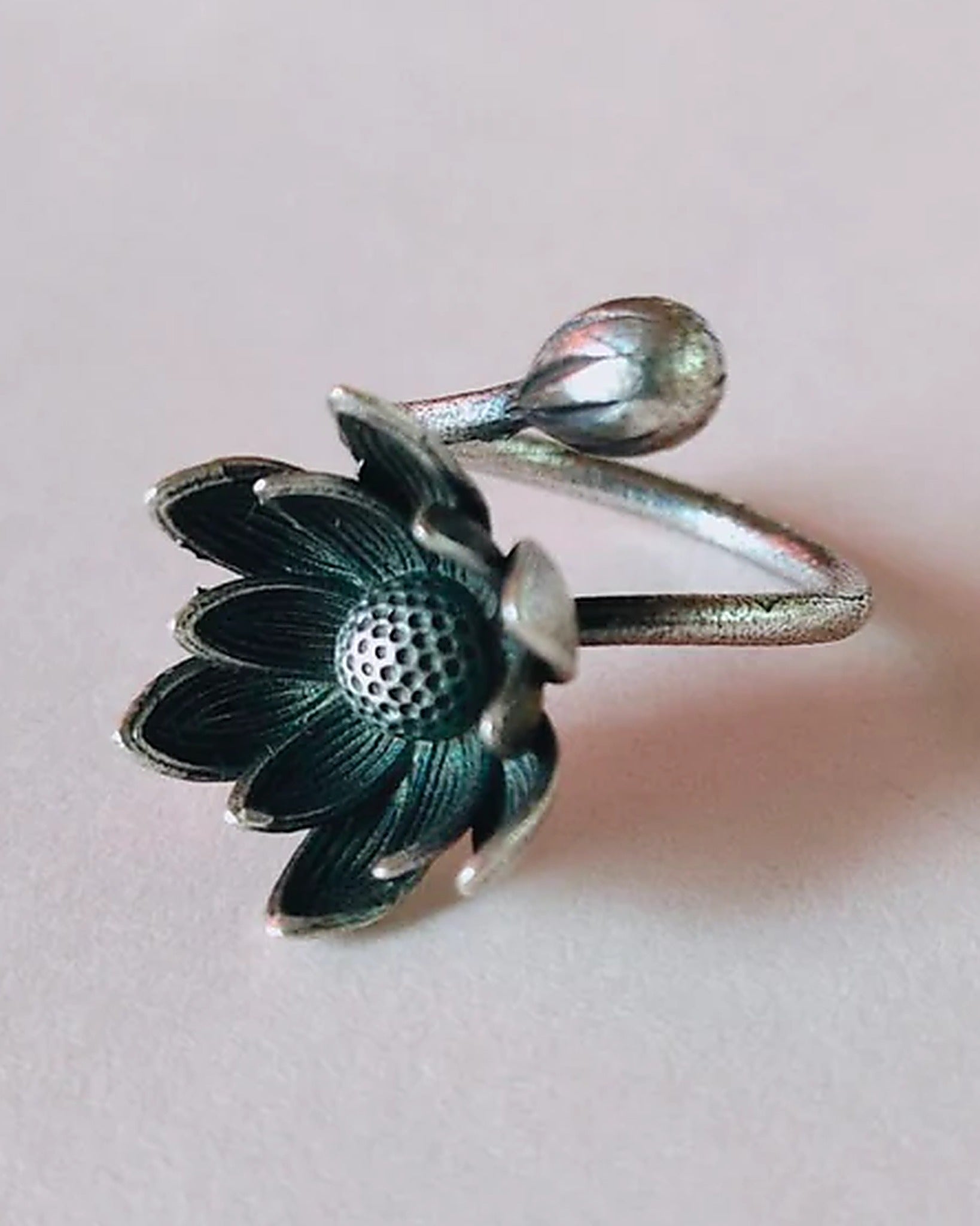 Oxidised silver-look brass adjustable ring with an open lotus bloom and a closed lotus bud on the wraparound band