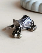 Oxidised silver-look brass statement ring shaped like a damru drum with small ghungroo bells at each end