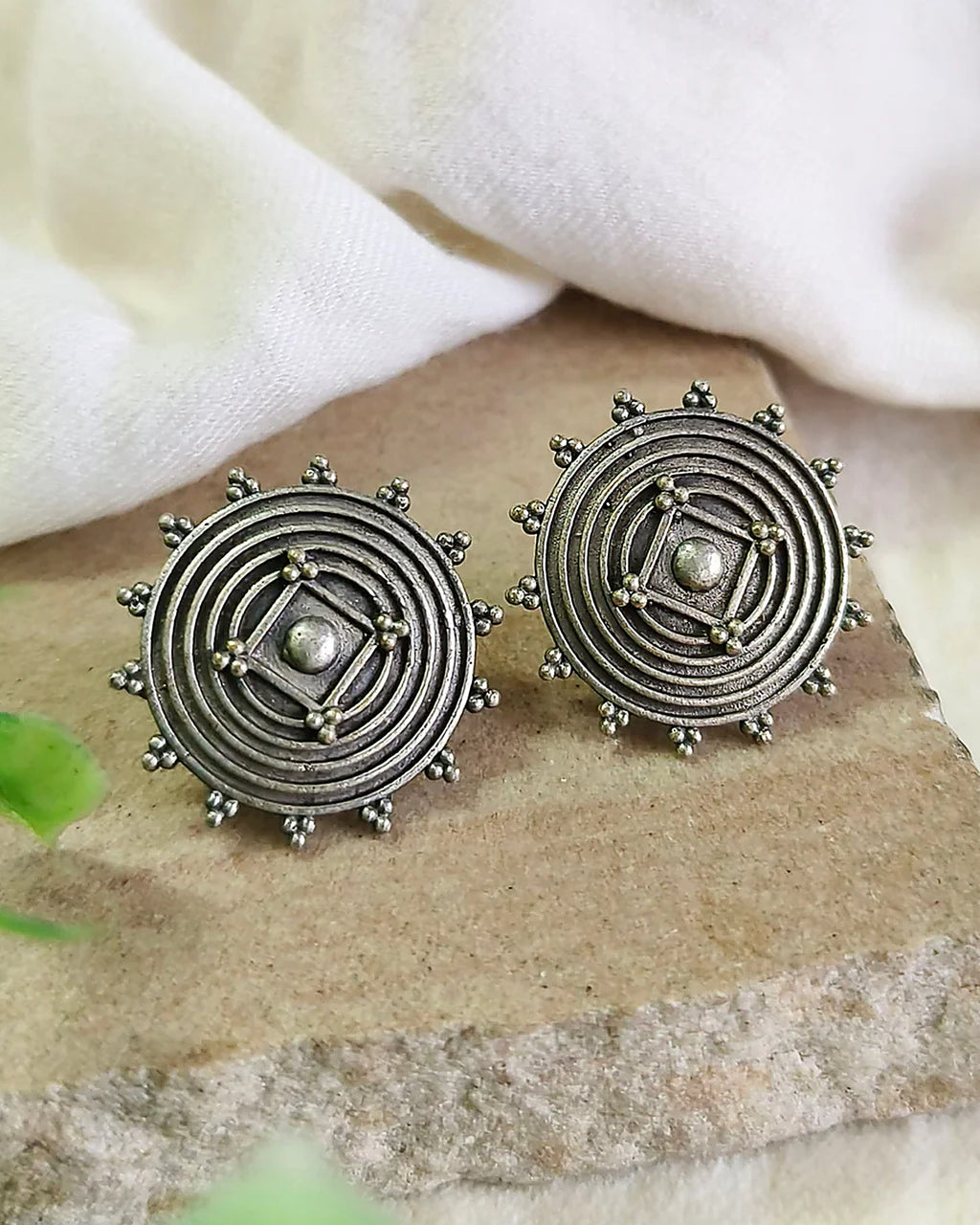Oxidised silver-look brass stud earrings with a concentric spiral centre and beaded rim
