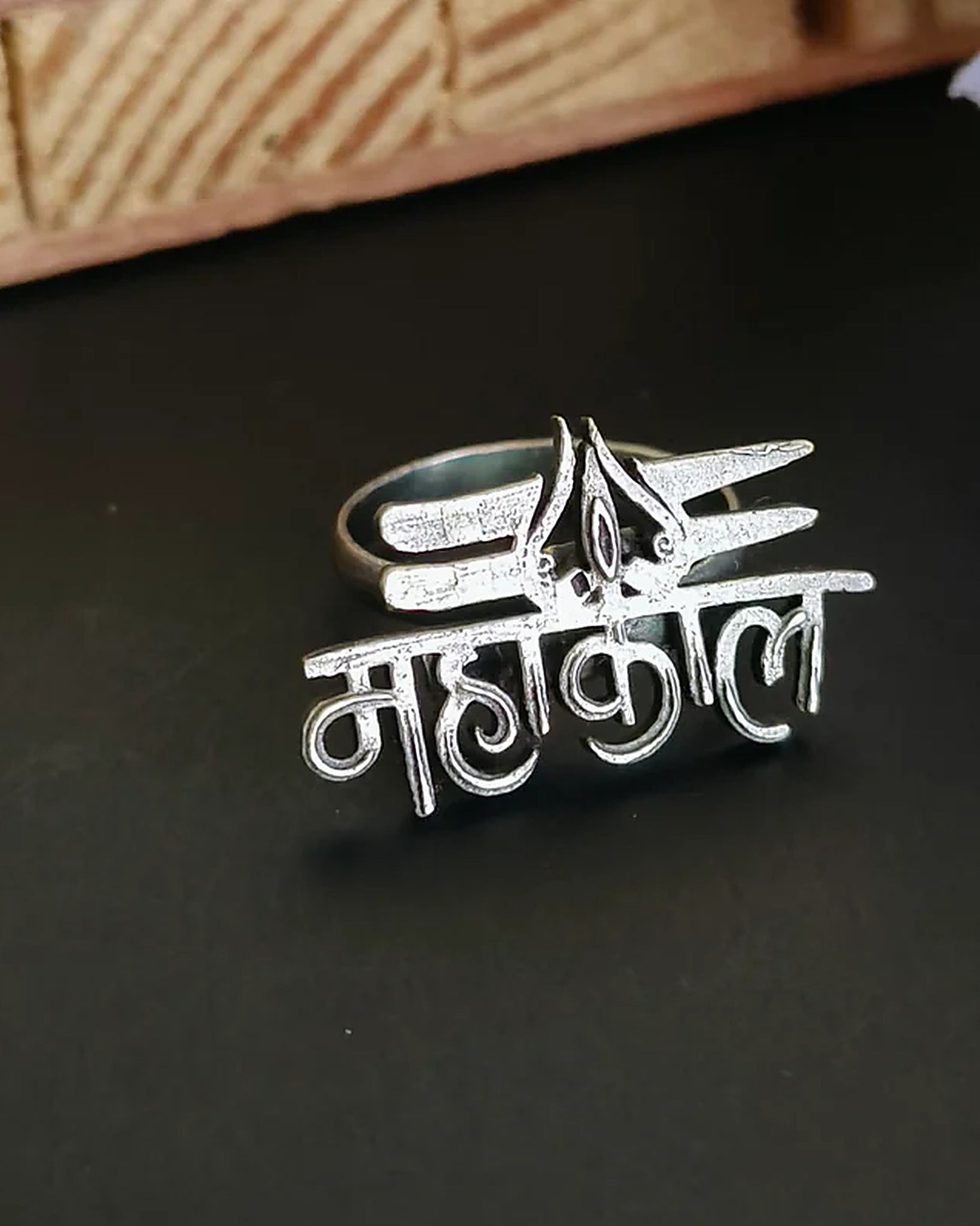 Oxidised silver-look brass statement ring with the Devanagari word महाकाल cut out and a trishul motif