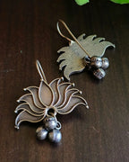 Oxidised silver-look brass drop earrings shaped as an open lotus with small ghungroo bells beneath