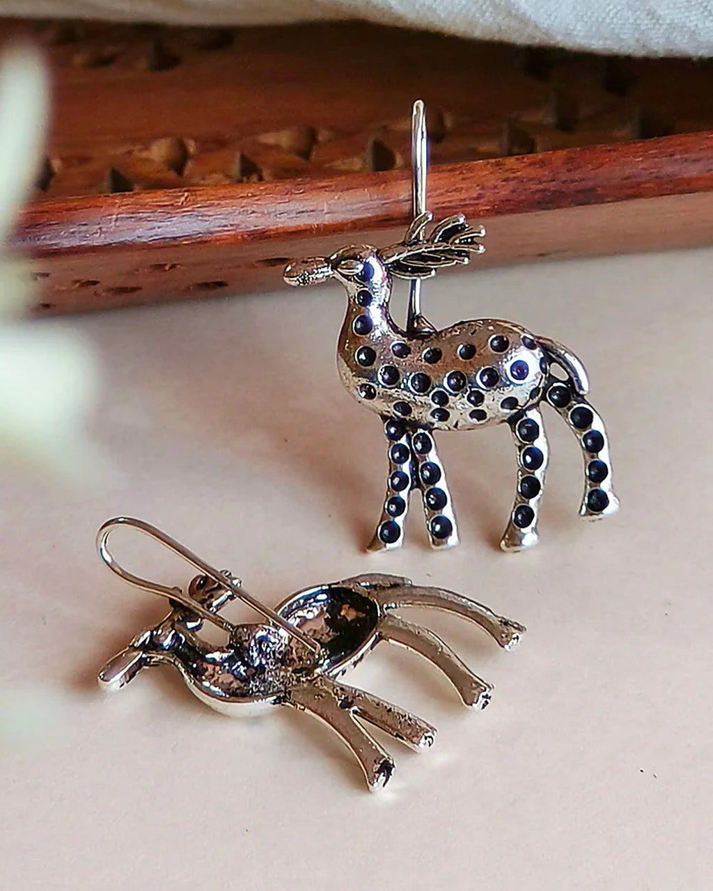 Oxidised silver-look brass drop earrings shaped as stags decorated with raised beadwork