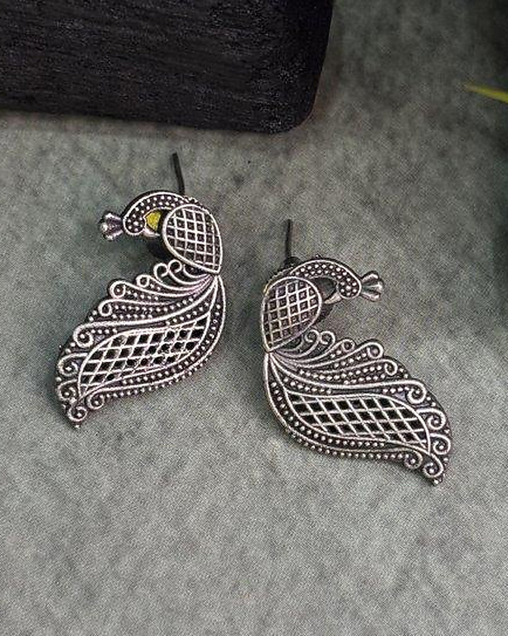 Oxidised silver-look brass drop earrings shaped as a peacock in fine open filigree work