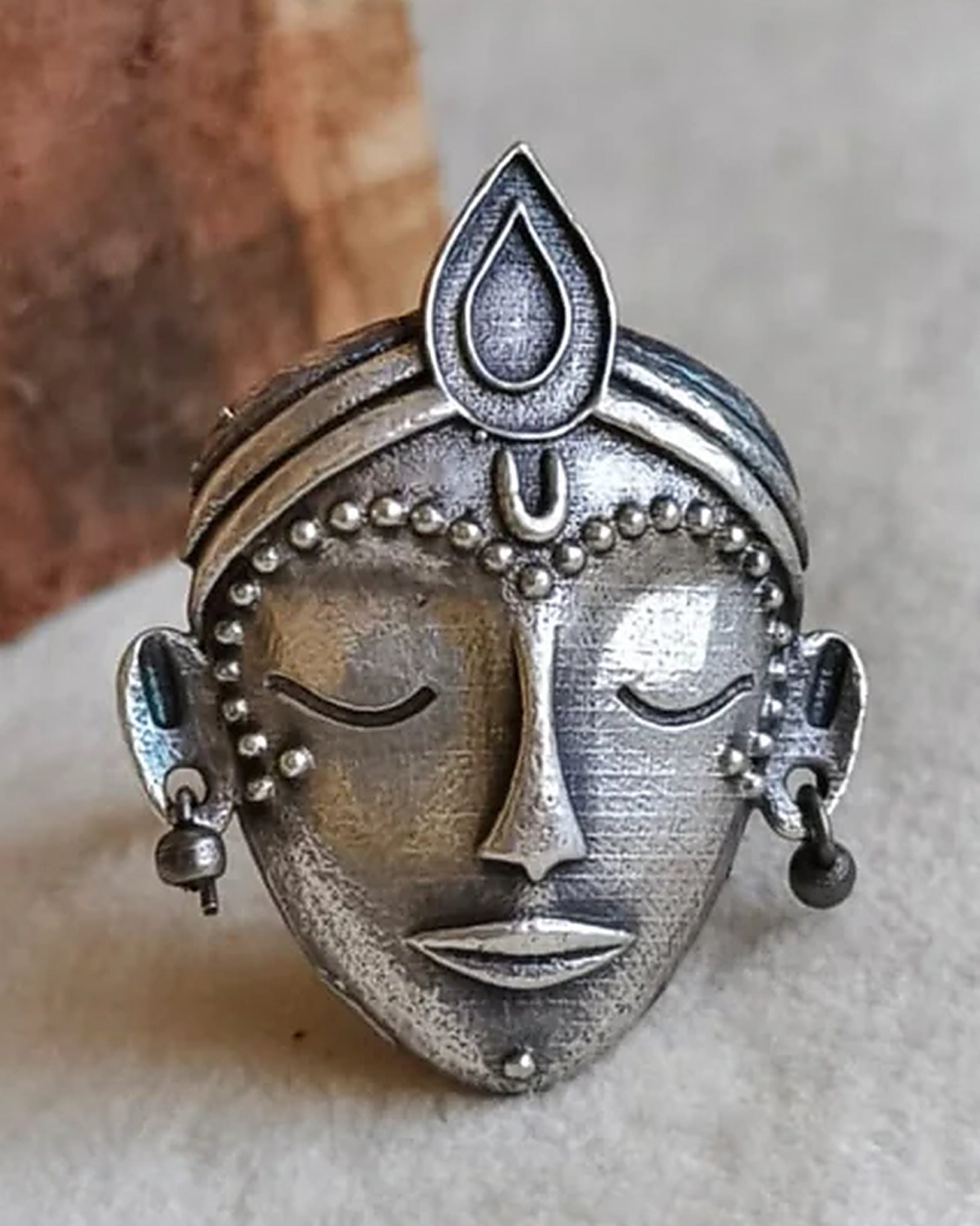 Oxidised silver-look brass adjustable statement ring featuring a crowned goddess face