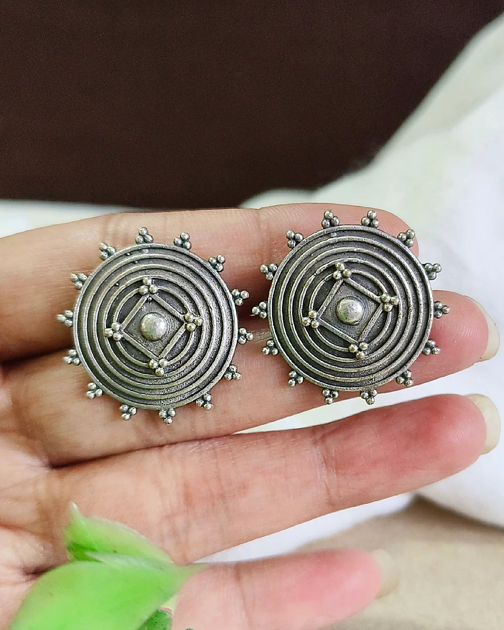 Oxidised silver-look brass stud earrings with a concentric spiral centre and beaded rim