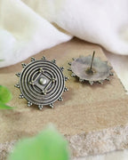 Oxidised silver-look brass stud earrings with a concentric spiral centre and beaded rim
