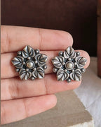 Oxidised silver-look brass stud earrings with layered flower petals edged in beadwork around a raised centre