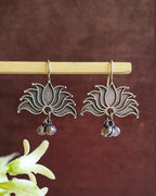 Oxidised silver-look brass drop earrings shaped as an open lotus with small ghungroo bells beneath