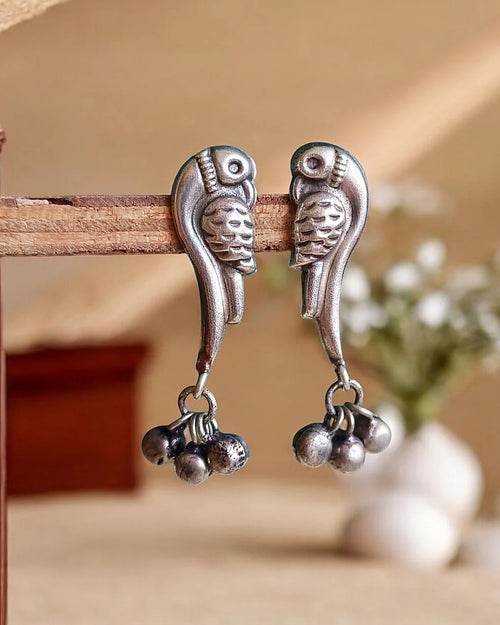 Oxidised silver-look brass drop earrings shaped as perched birds with clusters of small ghungroo bells