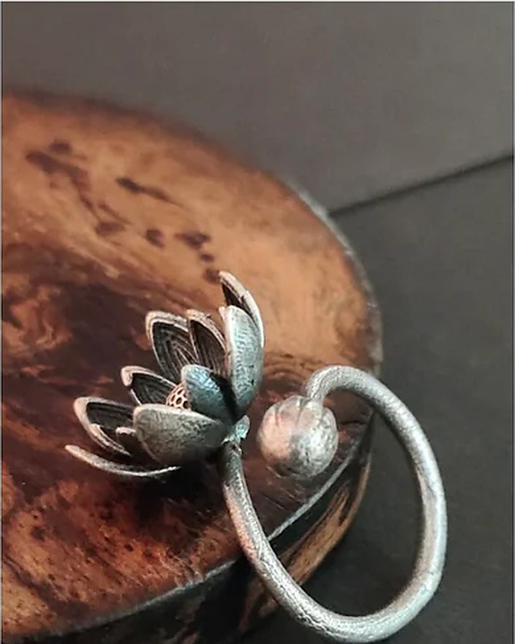 Oxidised silver-look brass adjustable ring with an open lotus bloom and a closed lotus bud on the wraparound band