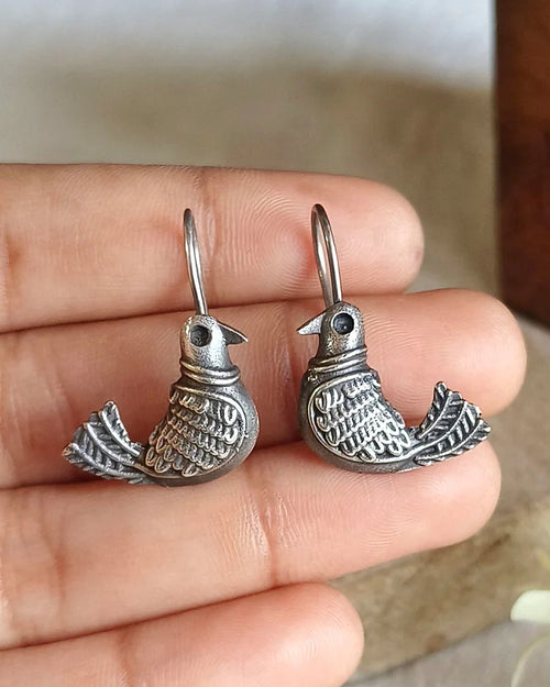 Oxidised silver-look brass drop earrings shaped as a bird in flight with fine engraved detailing