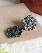 Oxidised silver-look brass stud earrings with layered flower petals edged in beadwork around a raised centre