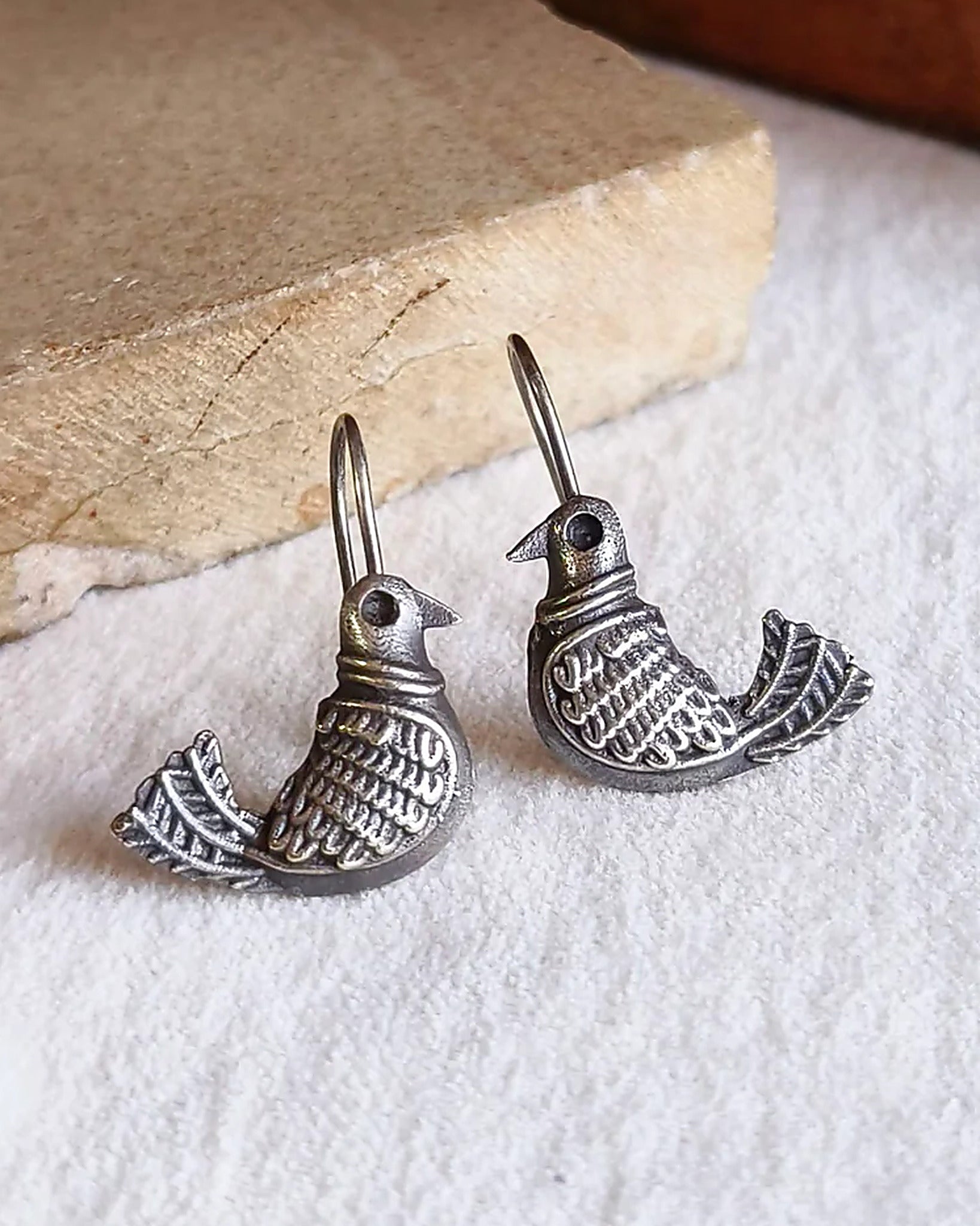 Oxidised silver-look brass drop earrings shaped as a bird in flight with fine engraved detailing