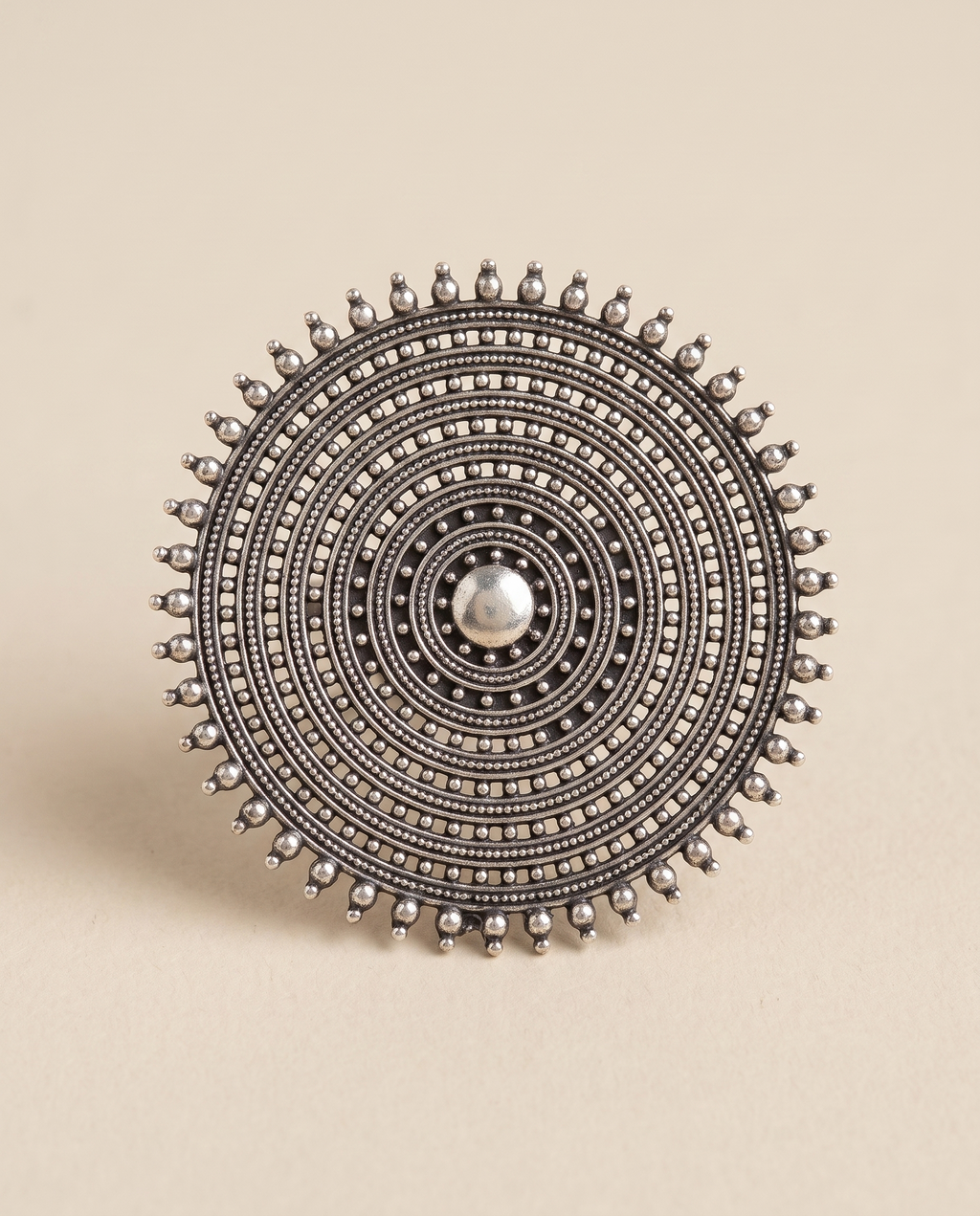 Nishan oxidised silver-look statement ring — a large disc of concentric beaded rings with a sunburst prong edge