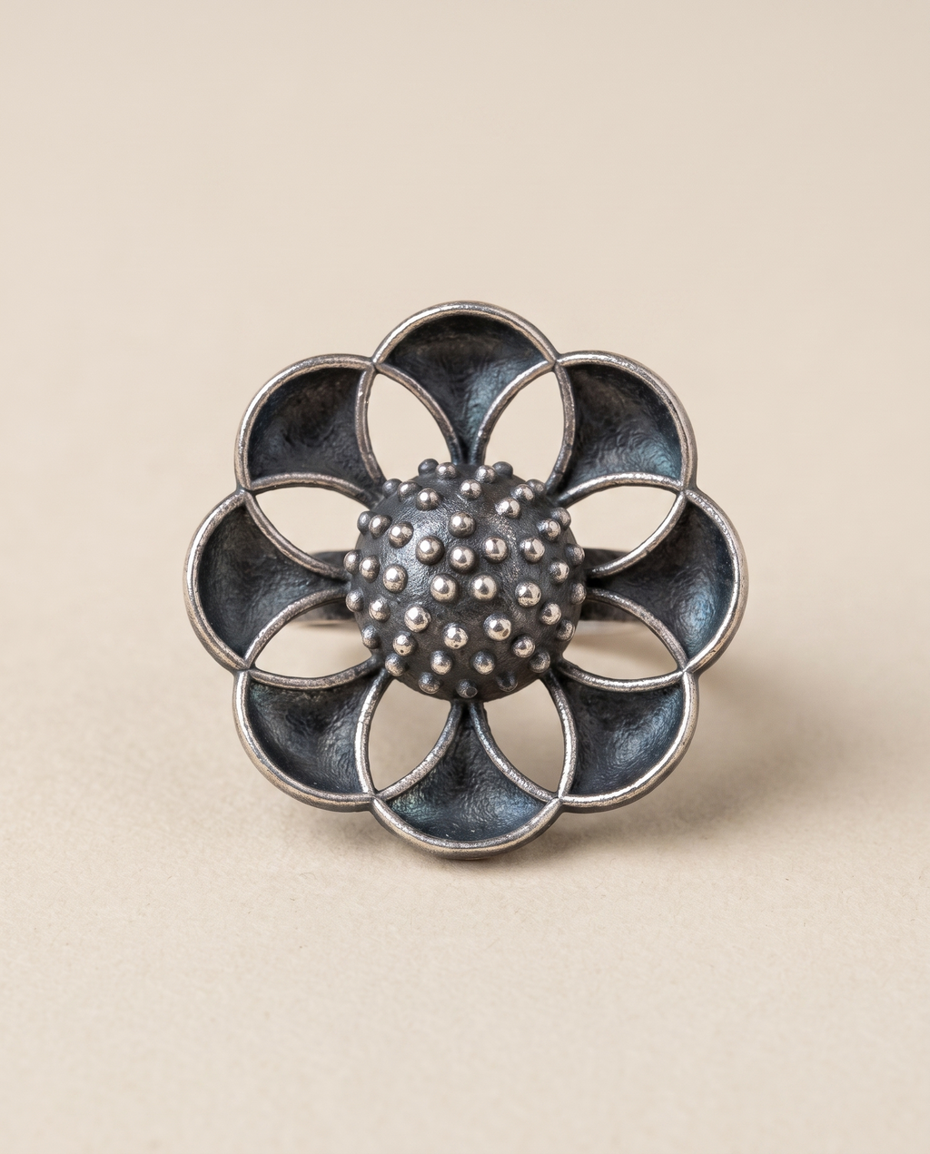 Vibha oxidised silver-look statement ring — eight overlapping petals arranged around a granulated centre dome