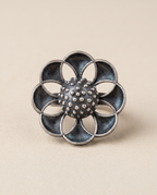 Vibha oxidised silver-look statement ring — eight overlapping petals arranged around a granulated centre dome