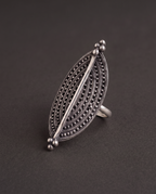 Close-up of the Virushka marquise ring on charcoal, showing the rows of fine granulation and the bright polished centre spine