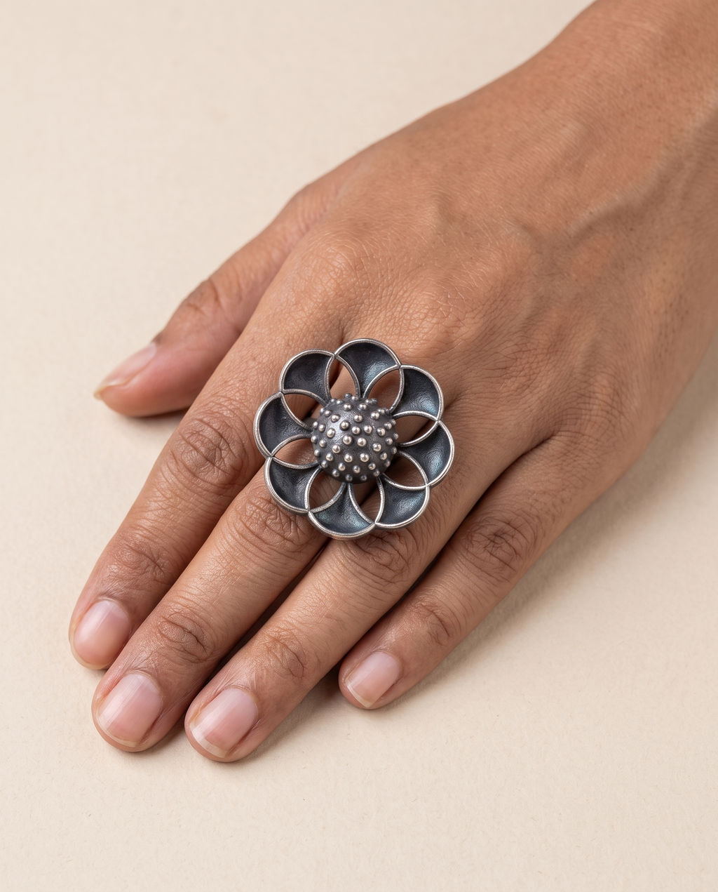 Vibha open-flower statement ring worn on the middle finger