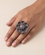 Vibha open-flower statement ring worn on the middle finger