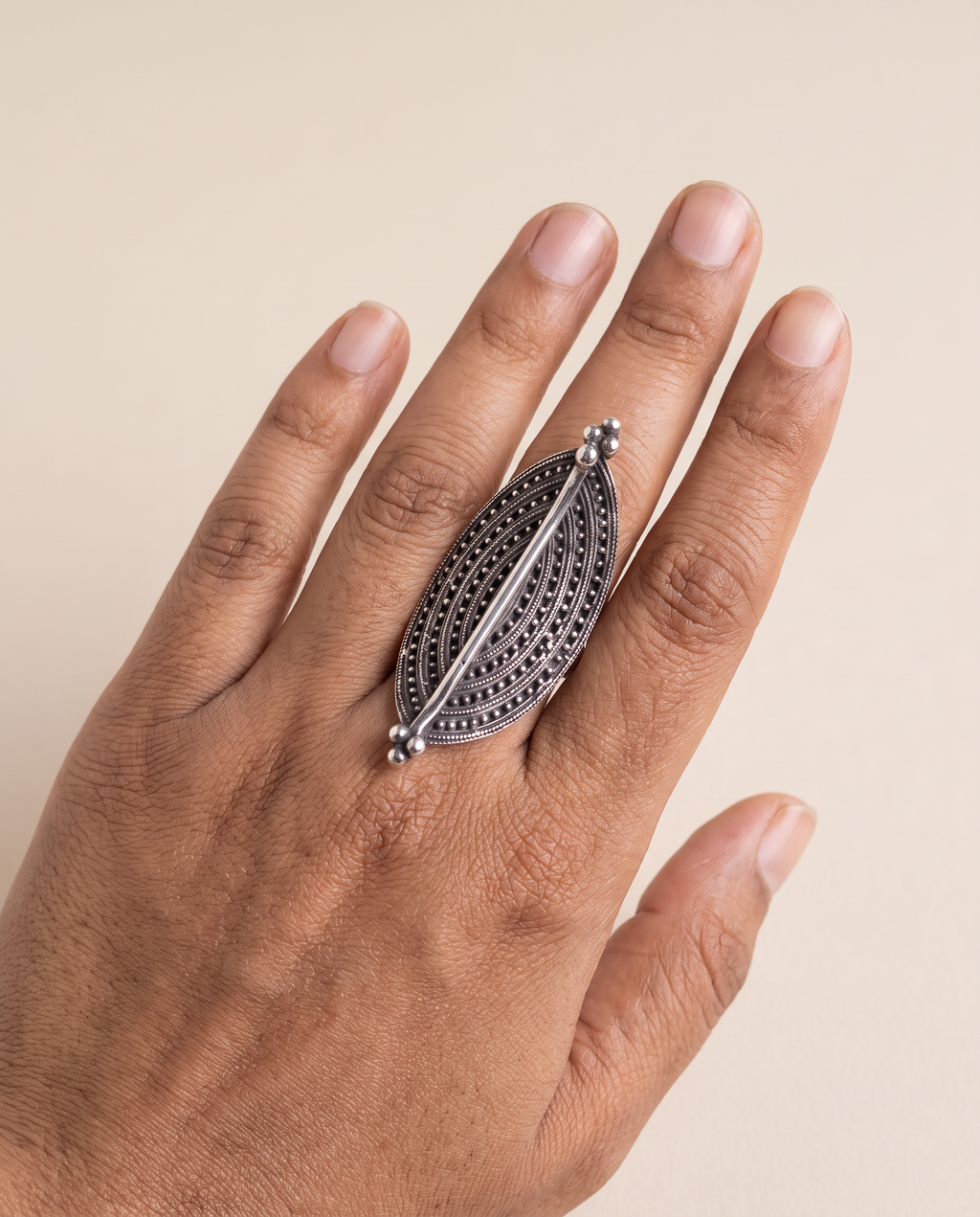 Virushka marquise ring worn lengthwise along the middle finger, showing how it elongates the hand