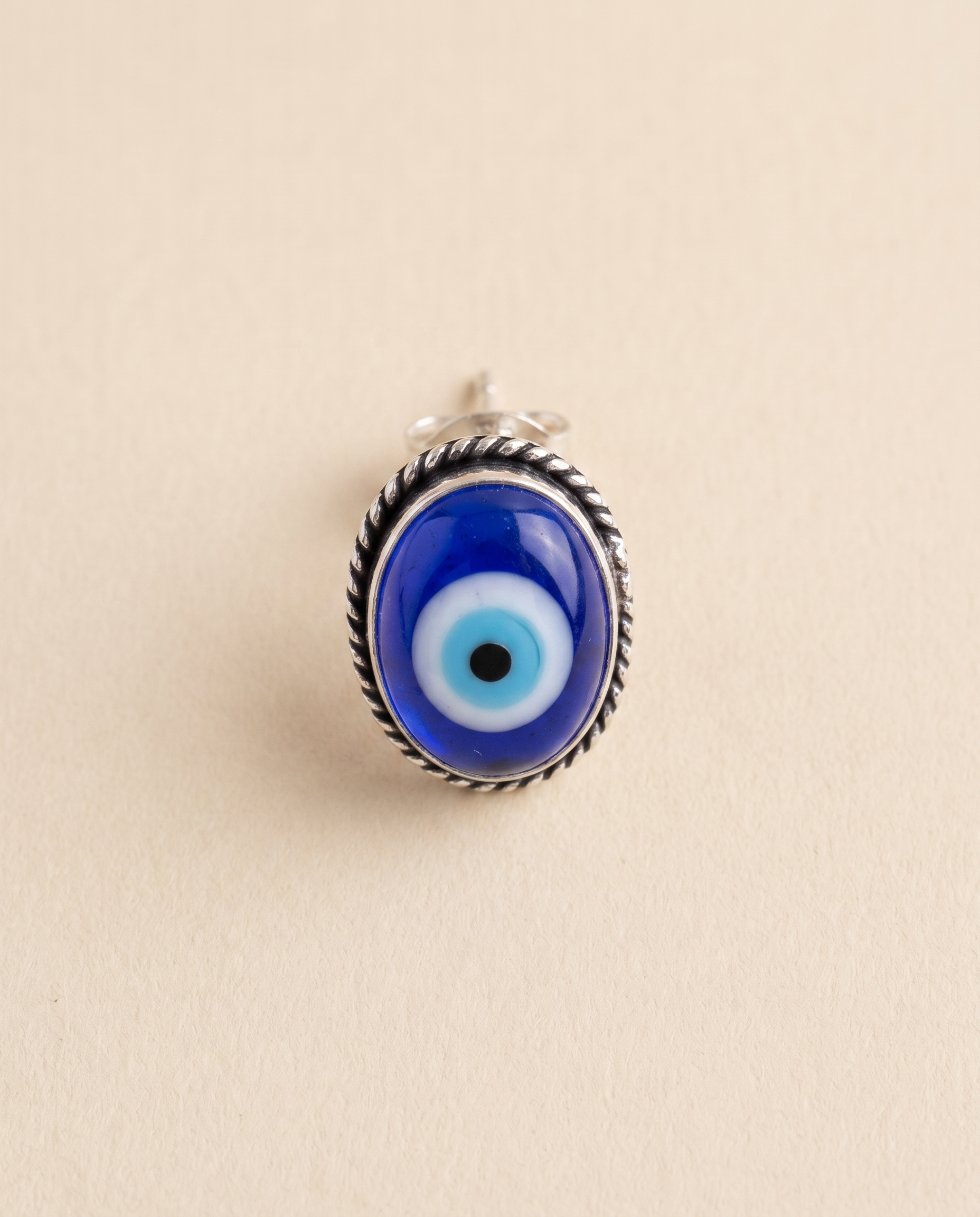 Nazar Battu cobalt blue evil eye stud earring in an oxidised silver rope-edged bezel