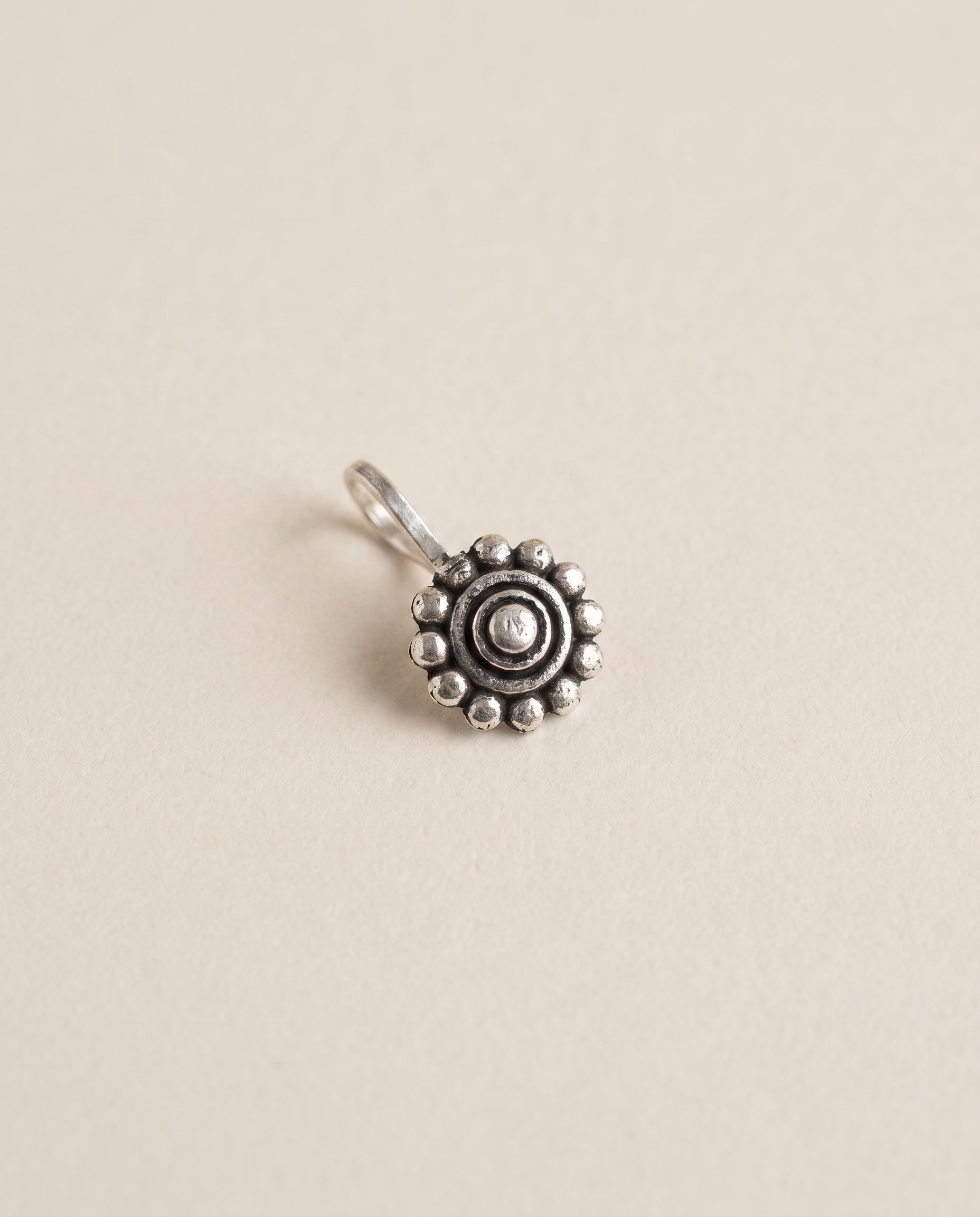 Phool oxidised silver-look round floral disc clip-on nose pin with a beaded border