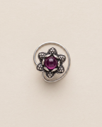 Divi oxidised silver-look floral nose pin with a deep magenta-purple centre stone and a curved wire fitting