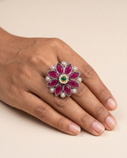 Anant stone-set flower statement ring worn on the middle finger