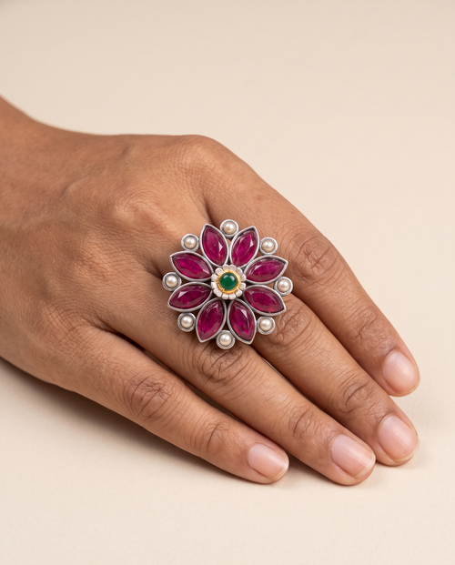 Anant stone-set flower statement ring worn on the middle finger