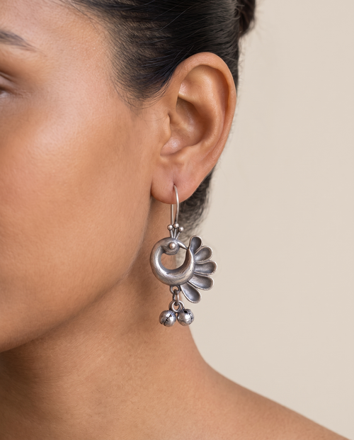 Chandrika crescent peacock earring worn on the earlobe