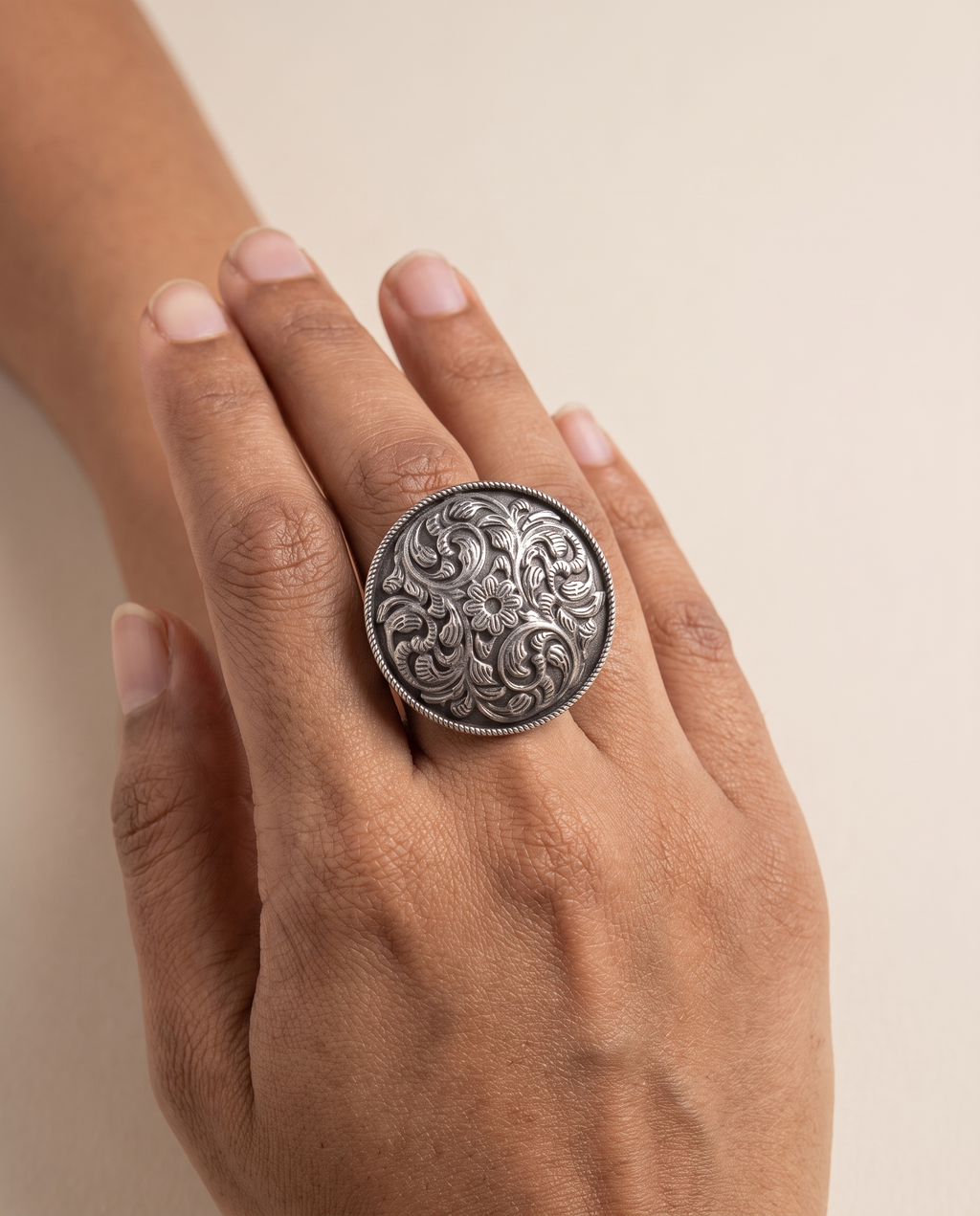 Vipra paisley dome ring worn on the middle finger