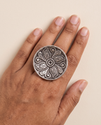 Ranchi engraved floral disc ring worn on the middle finger