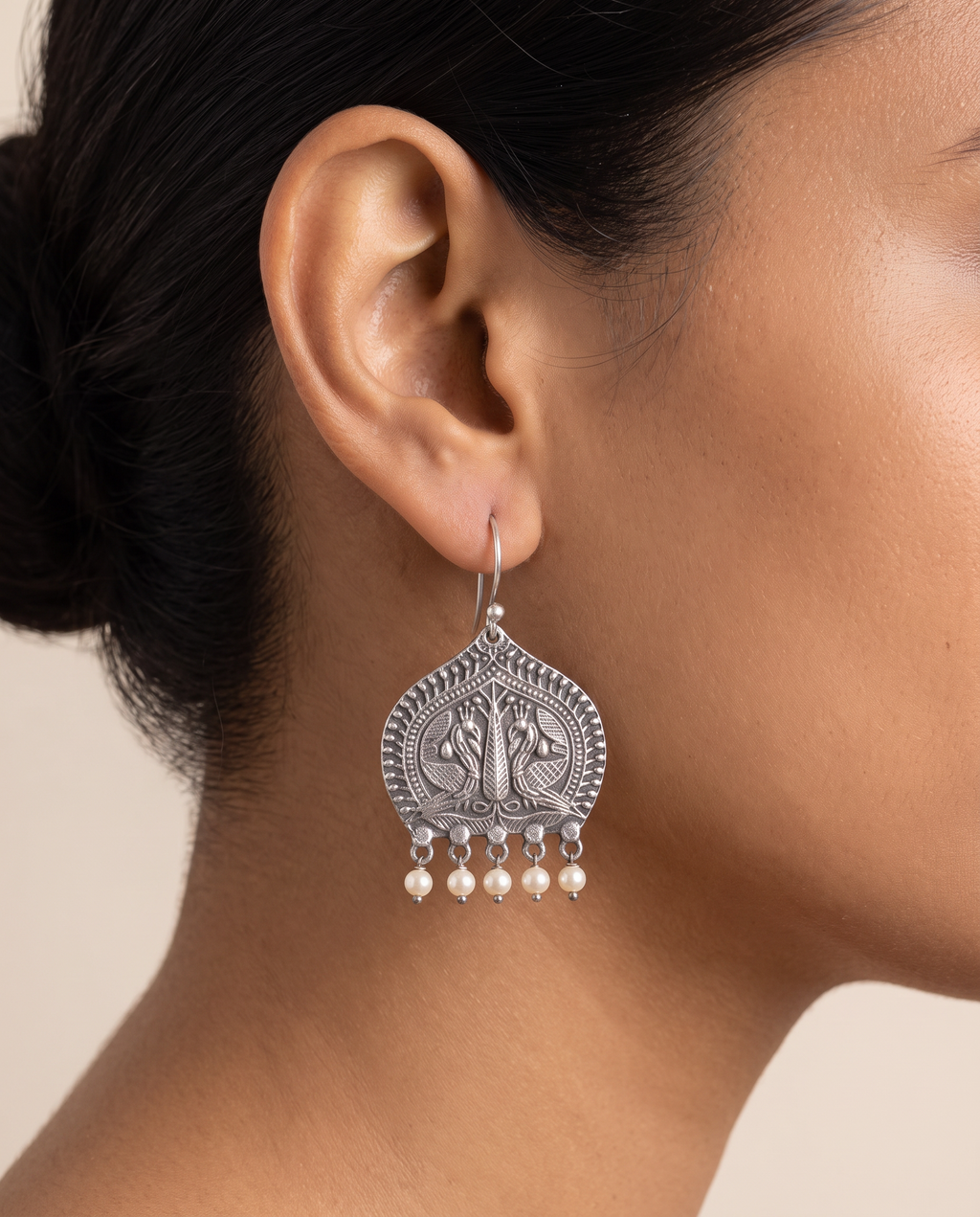 Madhuri paan leaf peacock earring with pearl drops worn on the earlobe