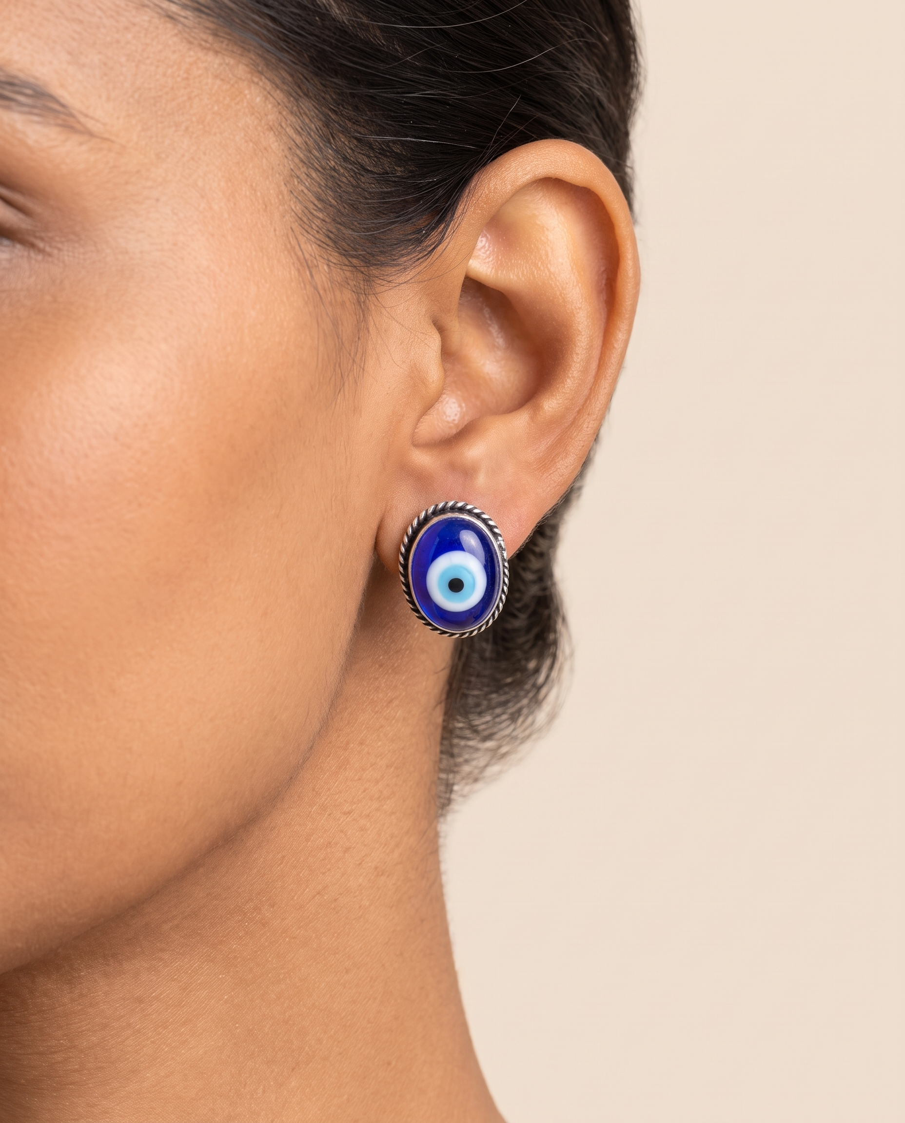 Nazar Battu evil eye stud earring worn on the earlobe