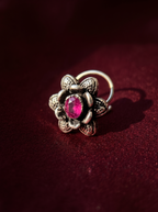 Urban Tevar Divi floral oxidised silver nose pin with purple stone, oxblood backdrop
