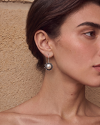 Freshwater pearl drop earrings worn on a model