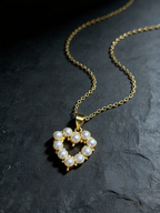 Pearl heart pendant necklace on a dark background