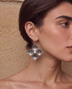 Pearl petal drop earrings worn on a model