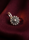 Urban Tevar Phool floral disc oxidised silver clip-on nose pin, oxblood backdrop