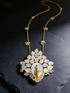 Royal Bloom gold-tone mother-of-pearl necklace on a dark background