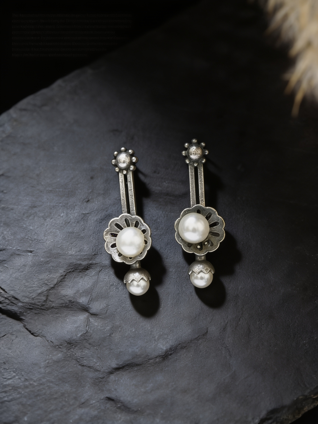 Sattu oxidised silver-look earrings on a dark background