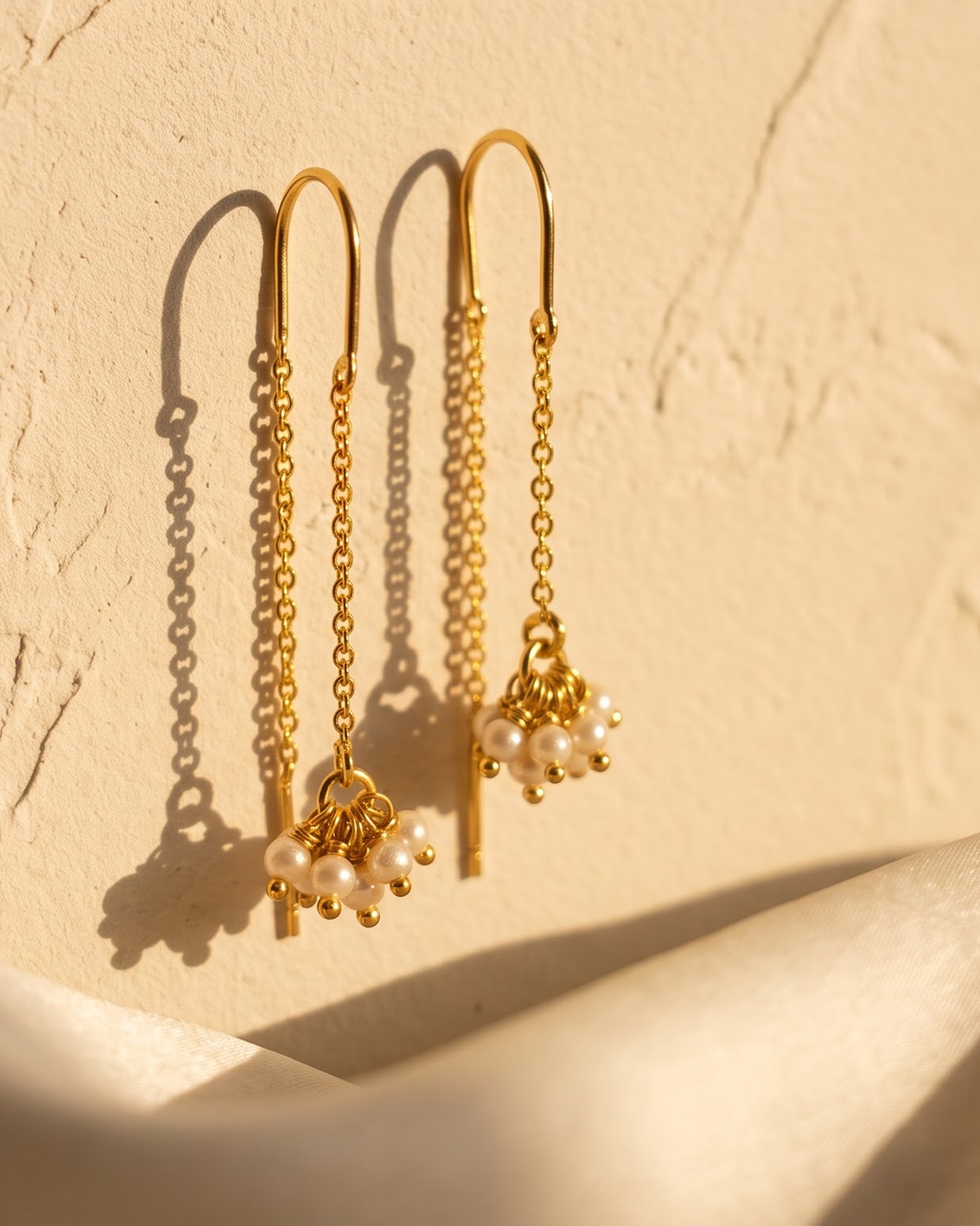 Sui dhaga pearl thread-through earrings on a light background