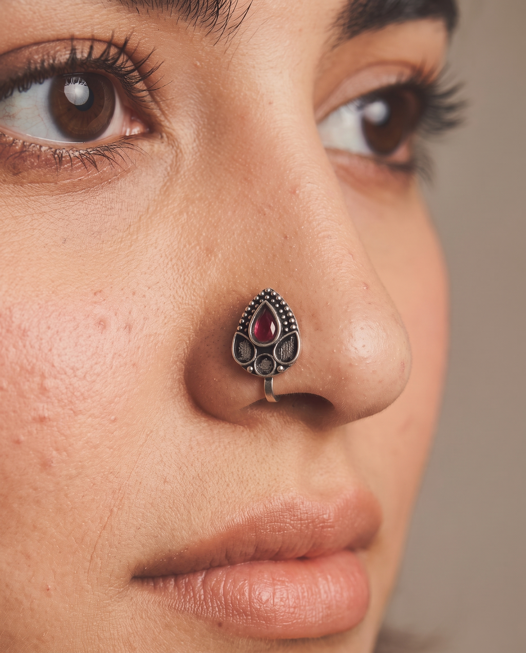 Urban Tevar Zari teardrop nose pin with red stone worn on model